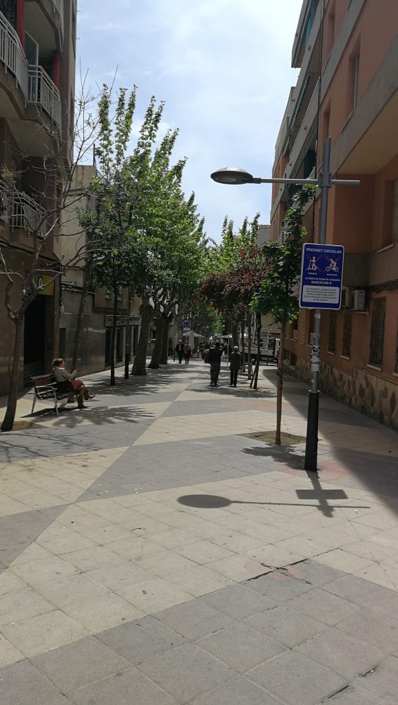 looking down the tree-lined pedestrianised Riera of Premià de Mar