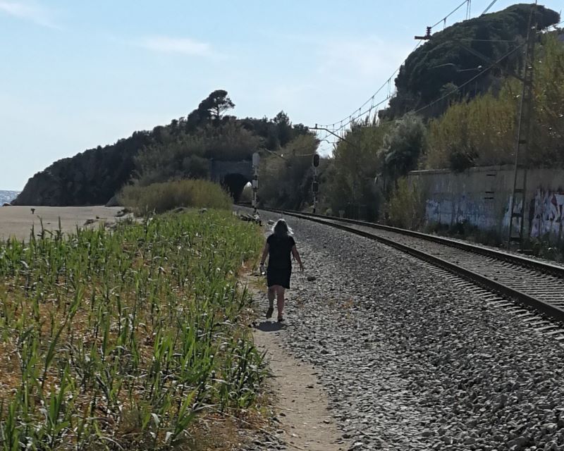 Alison strides out along the railtracks towards Canet de Mar