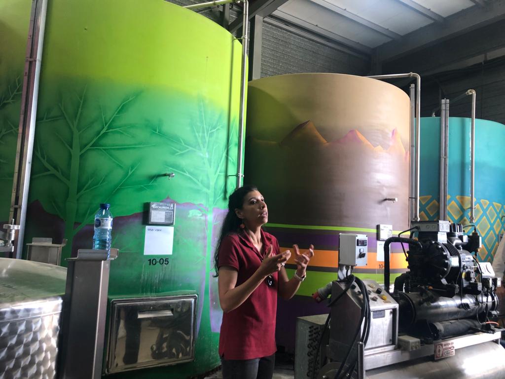 Pilar presenting her wine tour among the artistically rendered wine vats at Alta Alella
