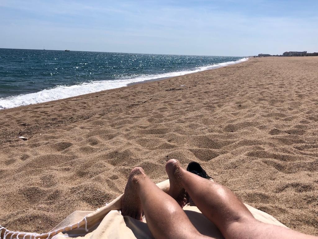 my legs in the sun on the beach at Malgrat to Mar